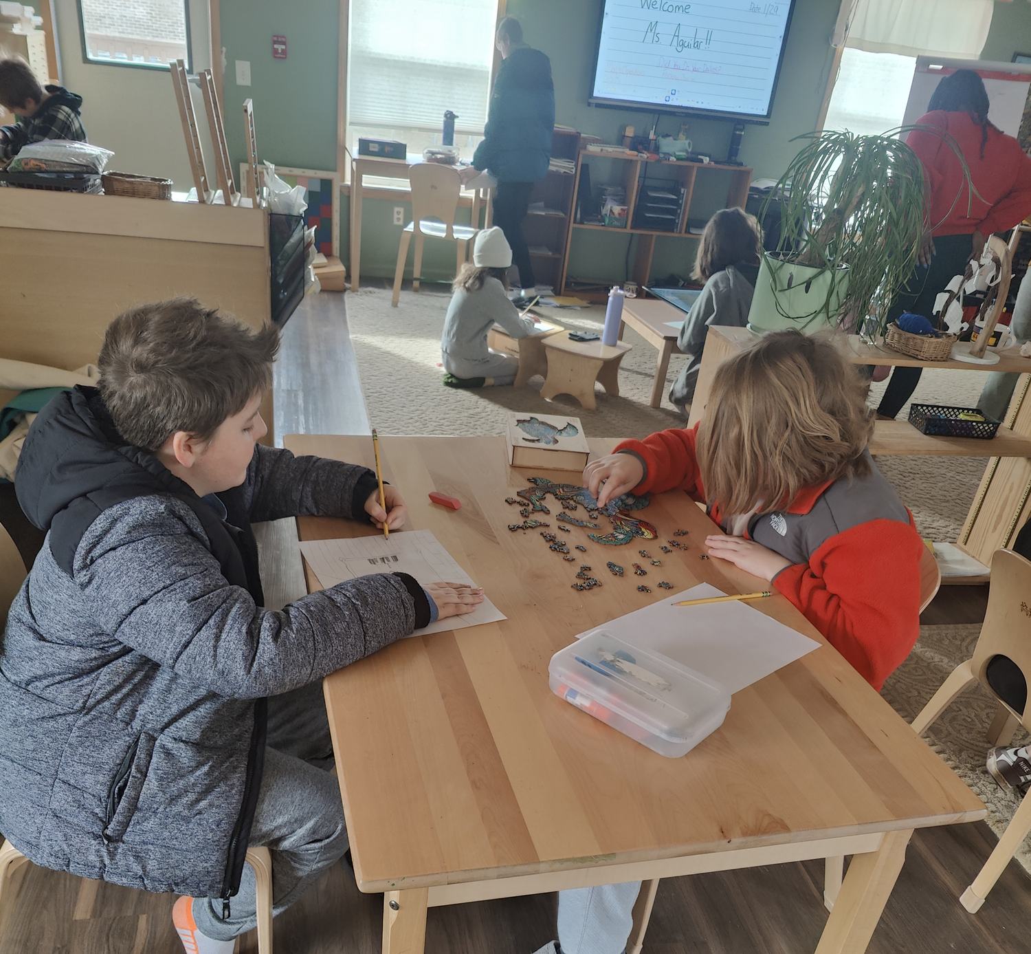 Elementary students working with hands-on materials